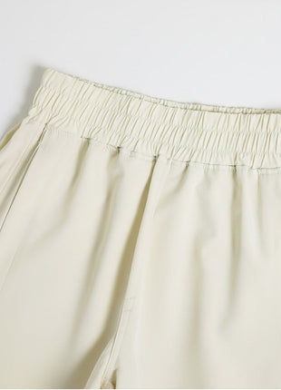 Elastic ribbed waistband of #ivory high rise split running shorts